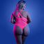 Back view of a curvy lingerie model wearing a neon pink glow-in-the-dark net teddy that features a thong-cut rear.
