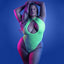 A plus size model wears a neon green glow in the dark teddy featuring a collared halter neck.