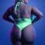 Back view of a plus size model wearing a neon green glow in the dark teddy featuring an open back with a thong style rear.