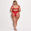 A plus-size lingerie model wears a red teddy with a strappy rear and criss-cross details at the small of the back.