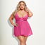 A curvy model wears a sheer flowy babydoll in pink lace and mesh with a gold rhinestone bow detail at the cleavage.
