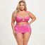 A curvy model wears a pink 3-piece lingerie set with a sternum cutout, underwired cups and small bow at the cleavage.