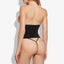 Back view of a model wearing a black thong under a power mesh shaping waist trainer that cinches in the waist.