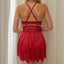 Back view of a red cutout lace and mesh babydoll with crisscross shoulder straps.  