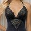Close up of a model wearing a black chemise with a v-shaped lace front. 