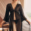 A model wears a full length sheer mesh split robe with a v-neck lined with scalloped lace. 