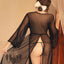A back view of a model wearing a full length sheer robe with a split rear down the middle. 