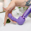 A hand is bending a ripple petite Le wand attachment that is attached to a purple massager. 