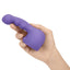 A hand holds a violet vibrator massager attachement made of silicone.