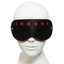 A black faux leather eye mask with red cutout hearts is worn on a mannequin's head, showcasing the contoured nose bridge.
