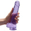 RealRock 9" Crystal Clear Realistic Dildo With Balls & Suction Cup has a lifelike sculpted phallic head, veiny shaft & testicles for safe anal or vaginal play. Purple-on hand.