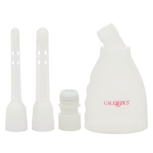 A clear douche stands upright next to the included nozzle attachments on a white background