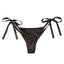 A pair of triangle-cut black panties with satin ribbon ties lay against a white backdrop. 
