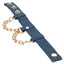 A denim handcuff lays flat and open with adjustable snap closures.