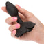 A hand model holds a black silicone rose anal plug for scale. 