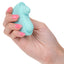 A hand model holds a blue compact clitoral thumping vibrator. 