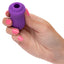 A hand model holds a mini purple clitoral suction teaser. 