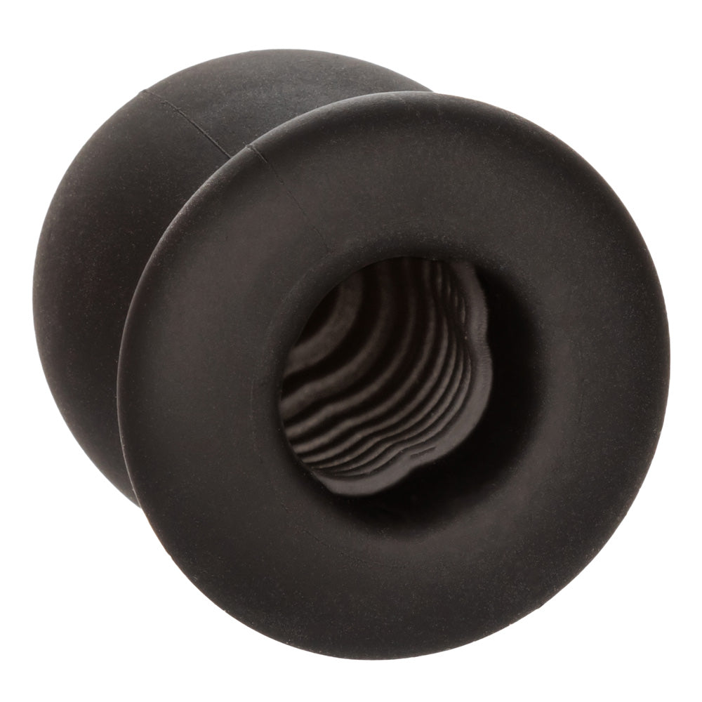 A black silicone stroker features an open base showcasing the ribbed texture inside the chamber.