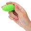 A hand model holds a mini neon green finger vibrator for scale.
