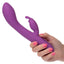 A hand model holds a warming g-spot rabbit vibrator for scale. 