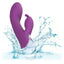 A purple rabbit warming g-spot vibrator is shown thrown in water to showcase its waterproof design. 