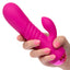 A hand model holds a hot pink thick g-spot vibrator for scale. 