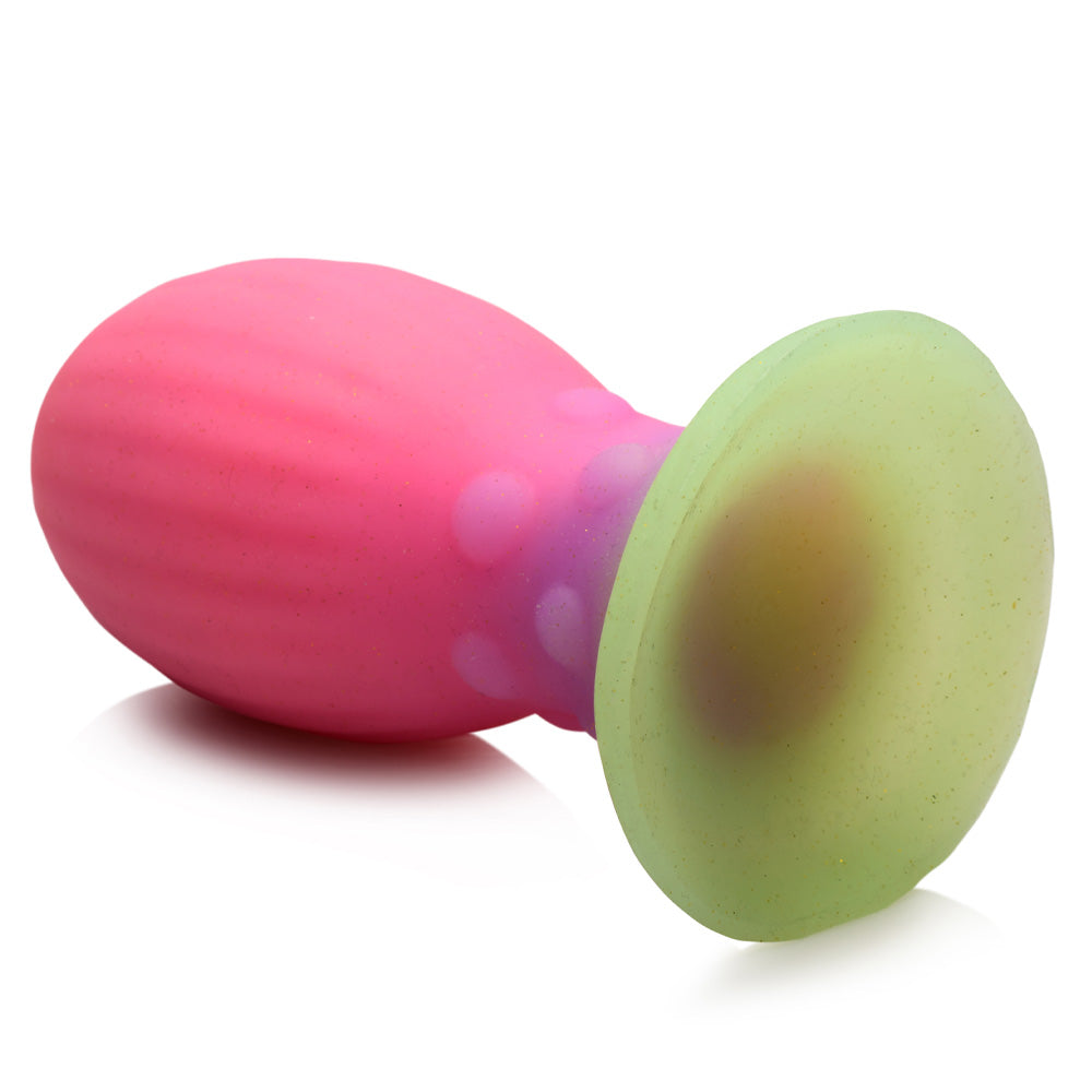 A back view of a Creature Cocks Xeno alien egg plug shows its flared suction cup base and beaded neck texture.