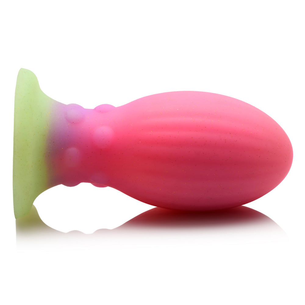 A side view of the Creature Cocks alien egg plug shows its bulbous ribbed body, beaded neck texture and suction cup.