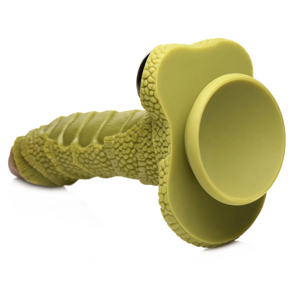 A back view of the green silicone Creature Cocks Swamp Monster dildo showcases its suction cup base.