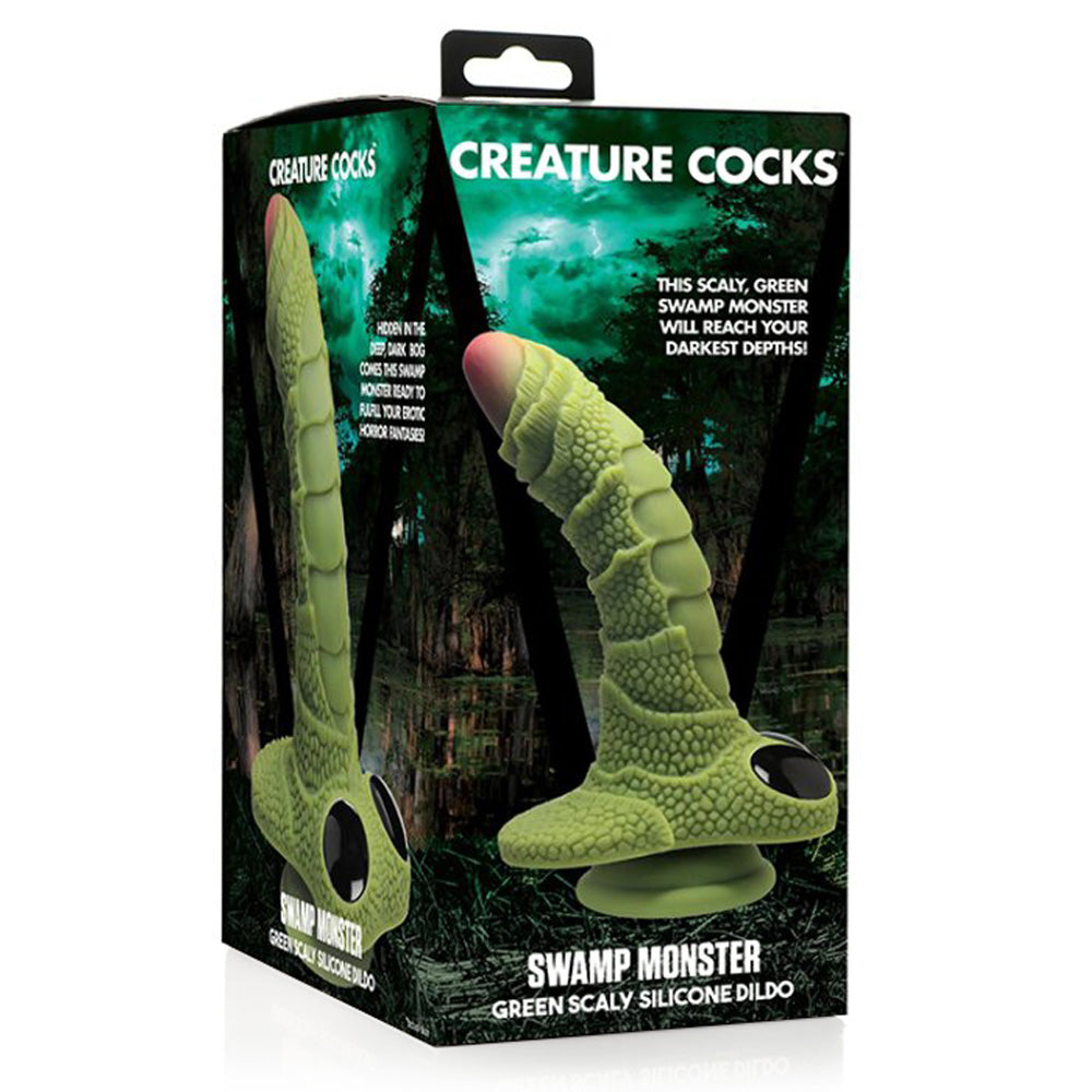 A box for the Creature Cocks Swamp Monster Dildo in green silicone sits against a white backdrop.