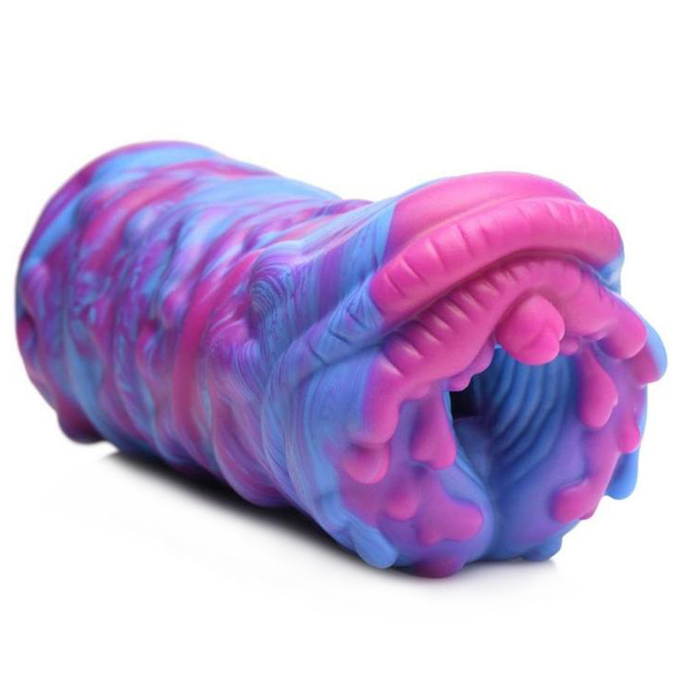 A Creature Cocks masturbator shows its alien vaginal opening and clitoris-like bump in marbled pink and blue silicone.