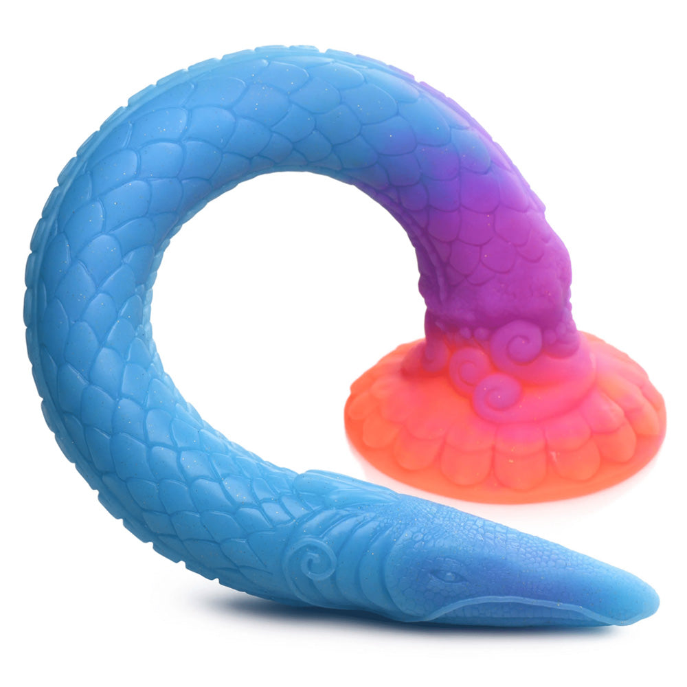 The glow-in-the-dark Makara sea snake dildo curls around itself to show a close-up of its dragon-like head and scaly shaft.