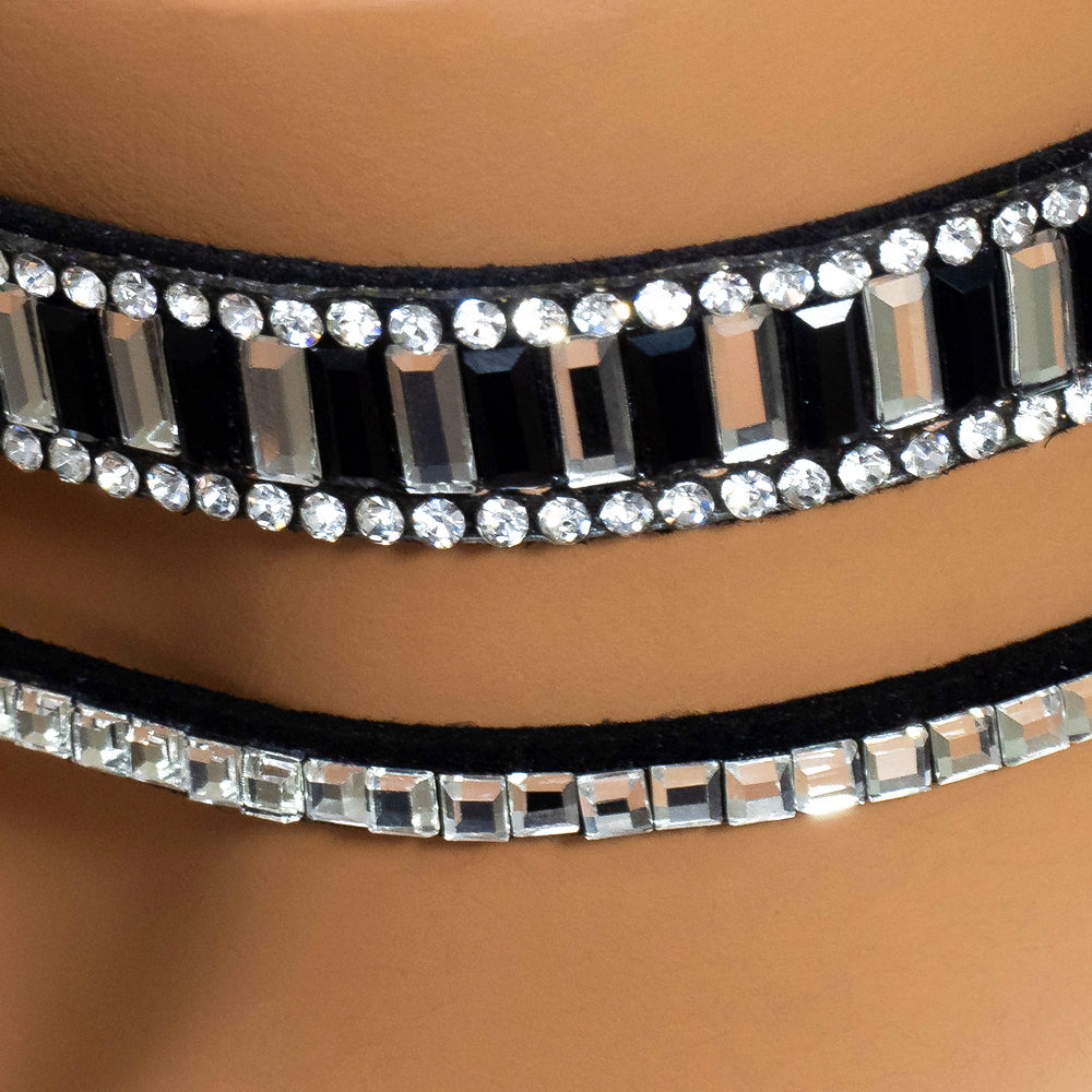 Close up of one thicker and one thinner black choker covered in diamanté’s worn on a mannequin’s neck.