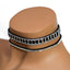 One thicker and one thinner black choker covered in diamanté’s worn on a mannequin’s neck.