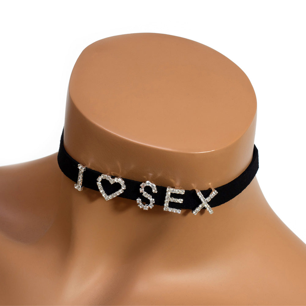 A black choker worn around a mannequin’s neck with the letters I heart sex on it encrusted with diamanté’s.