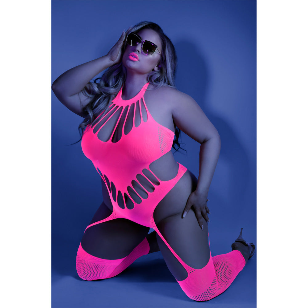 A plus size model wears a glow in the dark pink bodystocking with a v shape bodice and halter neck details.
