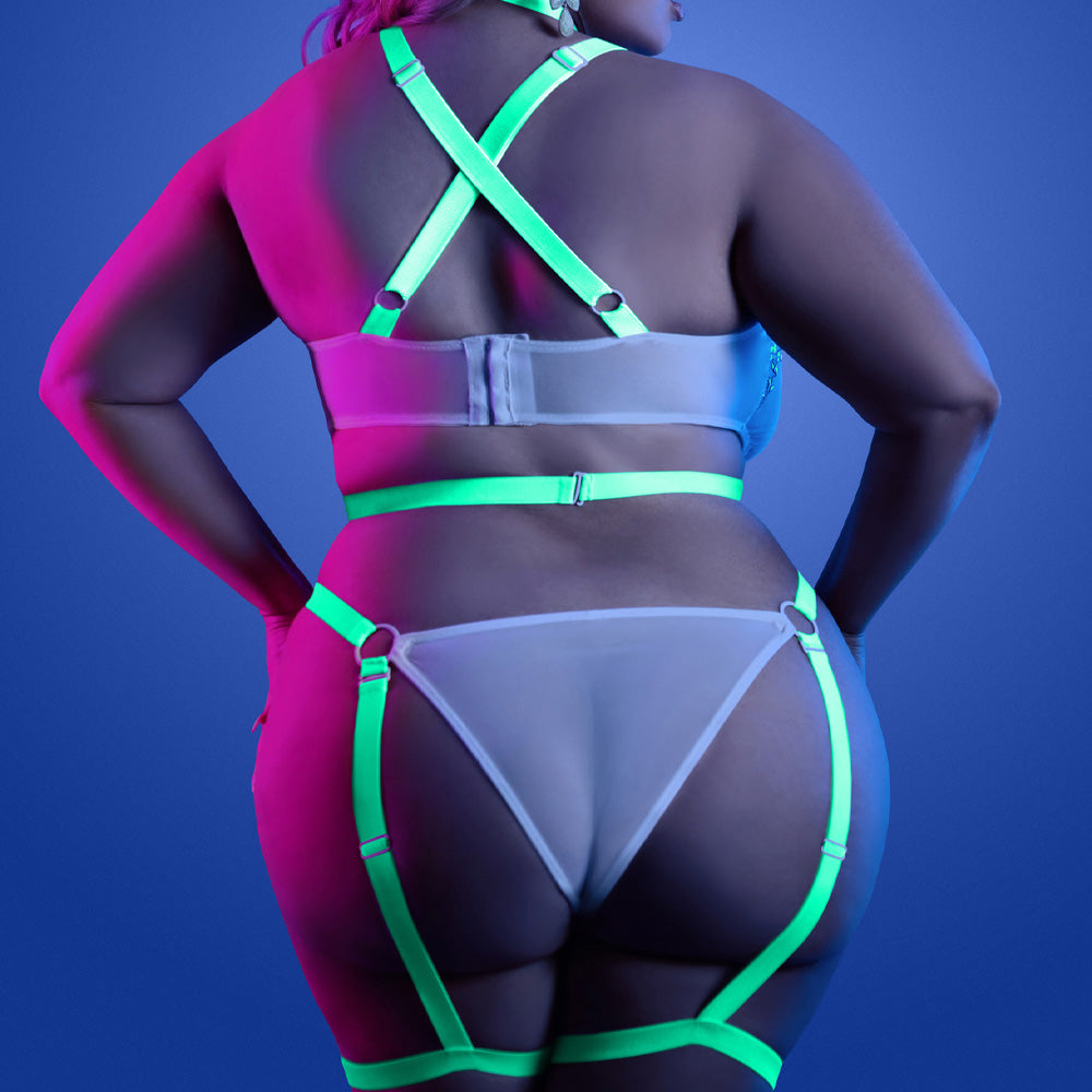 Back view of a plus size model wearing a cage strap gartered teddy with criss-cross shoulder straps and gartered suspenders.