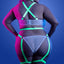 Back view of a plus size model wearing a cage strap gartered teddy with criss-cross shoulder straps and gartered suspenders.