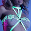 A close-up of a lingerie model wearing a glow-in-the-dark cage strap teddy that features a V-shaped collar design.