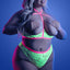 A plus-size model wears a glow-in-the-dark floral lace cupless bra with underwire support and matching high-waisted panties.