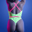 Back view of a lingerie model wearing a glow-in-the-dark teddy with criss-cross shoulder straps and thong-style bottoms.