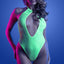 A model wears a neon green glow in the dark fishnet weave teddy with a keyhole cutout at the bust. 