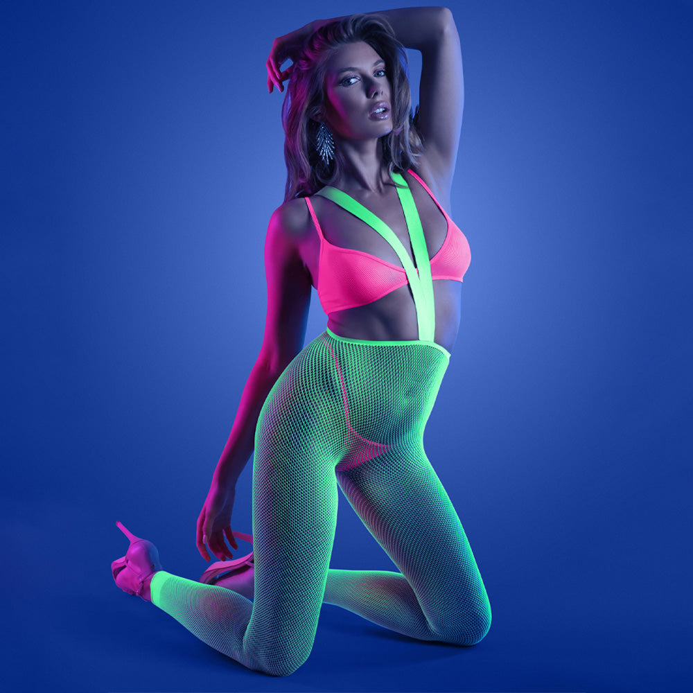 A model wears a glow in the dark fishnet suspender stocking with a v-shaped elastic halter neck strap attached to the waist.