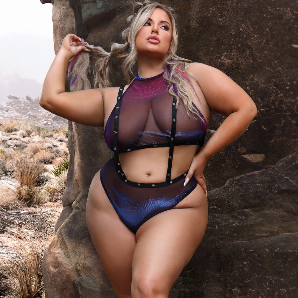 A plus size model wears a sheer halter top and panty with attached suspenders that have silvers stars printed on them.