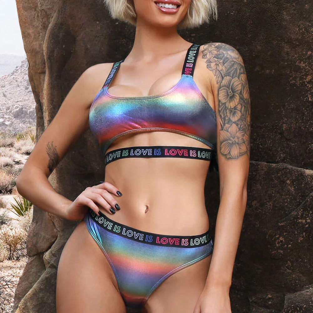 Close up of model wearing a rainbow holographic finish bralette and panty set by Fantasy Lingerie with split underbust trim. 