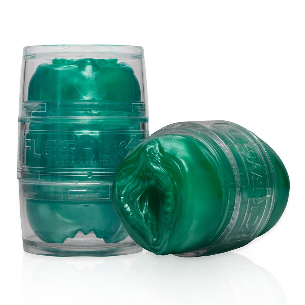 2 Fleshlight Alien Quickshots sit next to each other, one in a closed clear case and the other showing its openings.