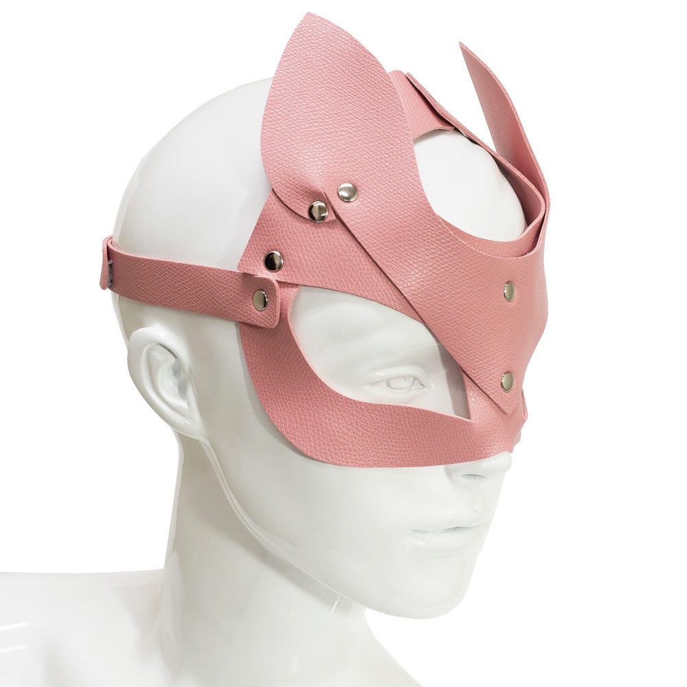 Side view of a mannequin wearing a baby pink faux leather fox mask with pointed ears and angular eye openings.