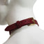 Back view of burgundy leather choker collar shows its gold adjustable buckle & leather tail keeper on a mannequin's neck.