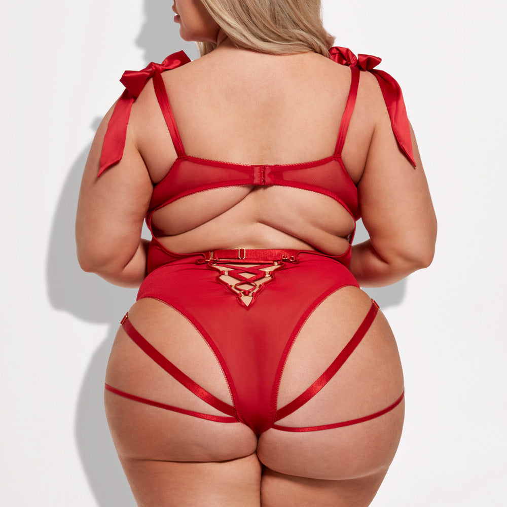 Back view of a curvy model wearing a red teddy with a corset-style criss-cross detail at the small of the back.