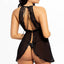 Back view of a model wearing a black babydoll with a halter-tie neck, lace shoulders framing the open back and flyaway skirt.
